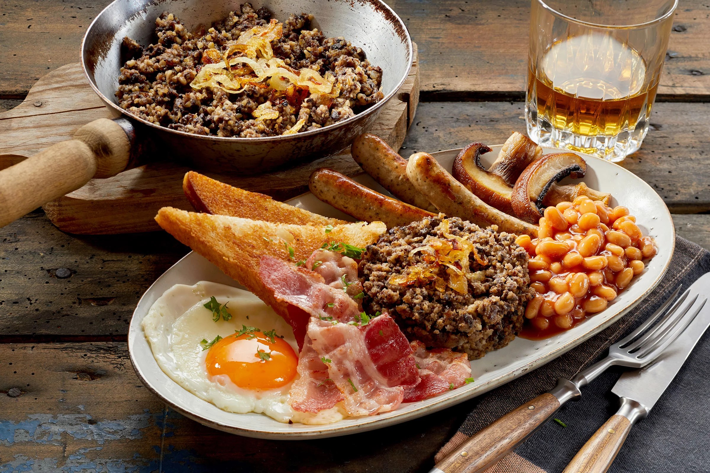 A perfect Scottish dish: hearty breakfast with haggis and a glass of Scotch